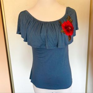 Blue ruffle off the shoulder flower appliqué top. Size S